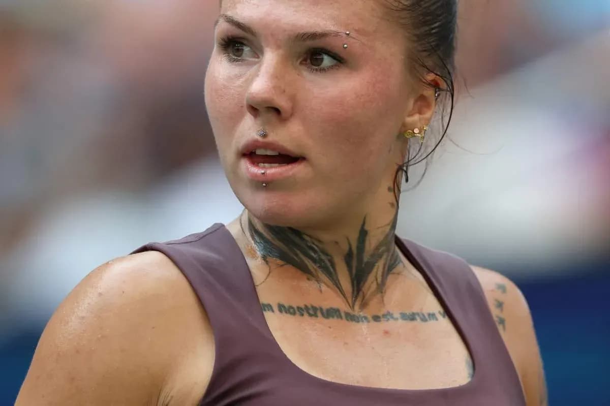 Athlete with tattoos and piercings during competition