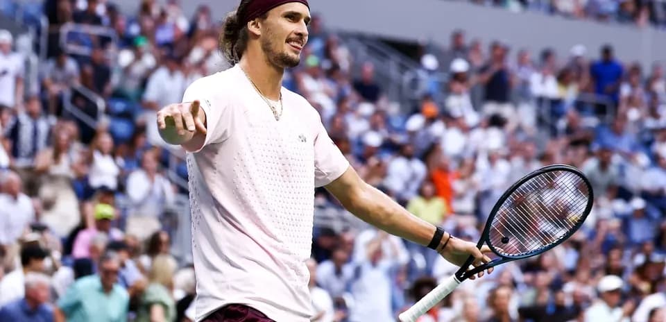 Player gesturing to the crowd during tennis match