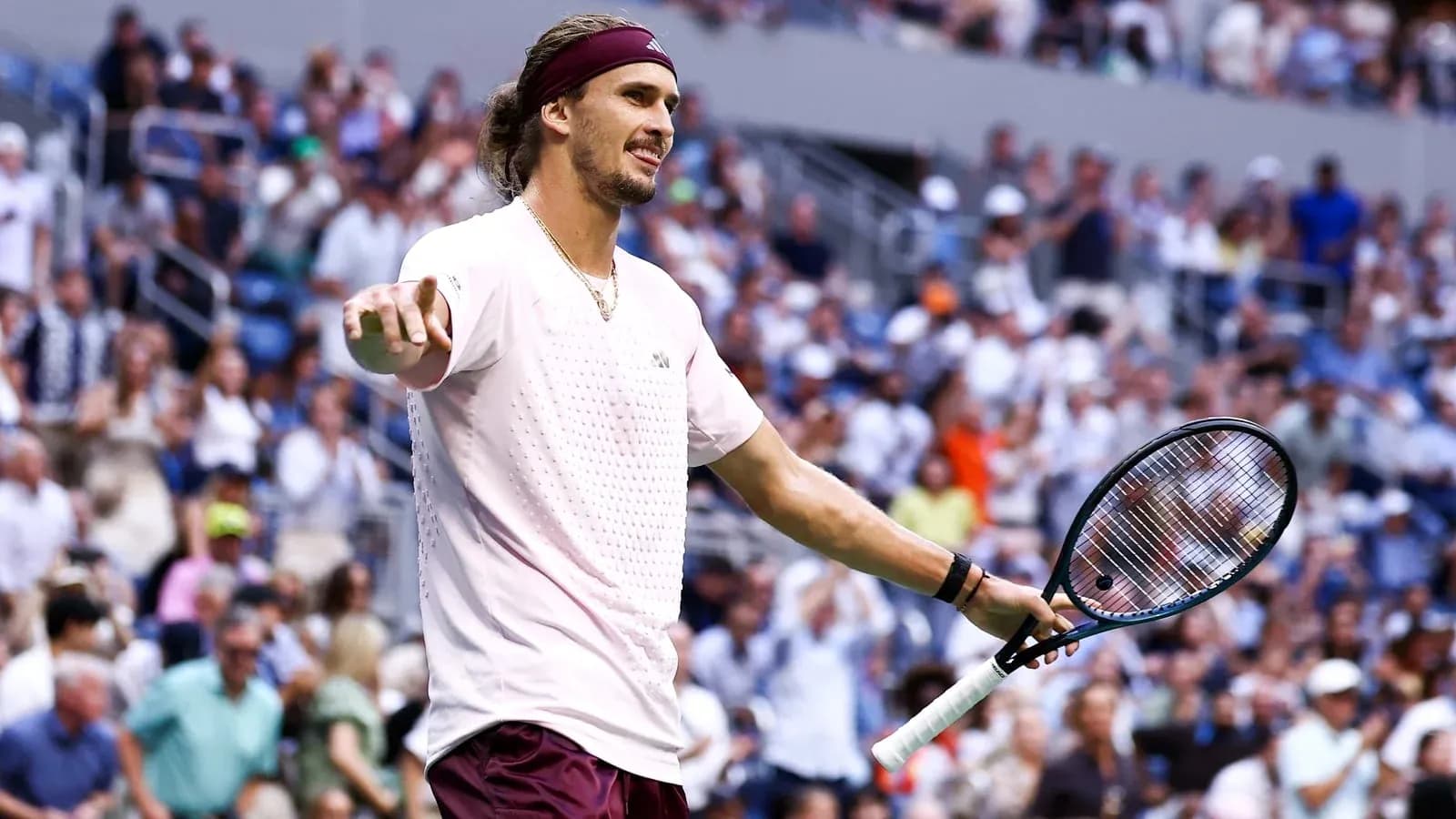 Player gesturing to the crowd during tennis match