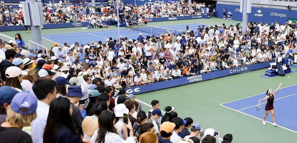 Crowd watching tennis match at stadium
