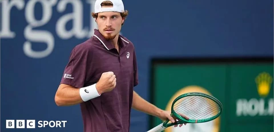 Tennis player celebrating with racquet at tournament