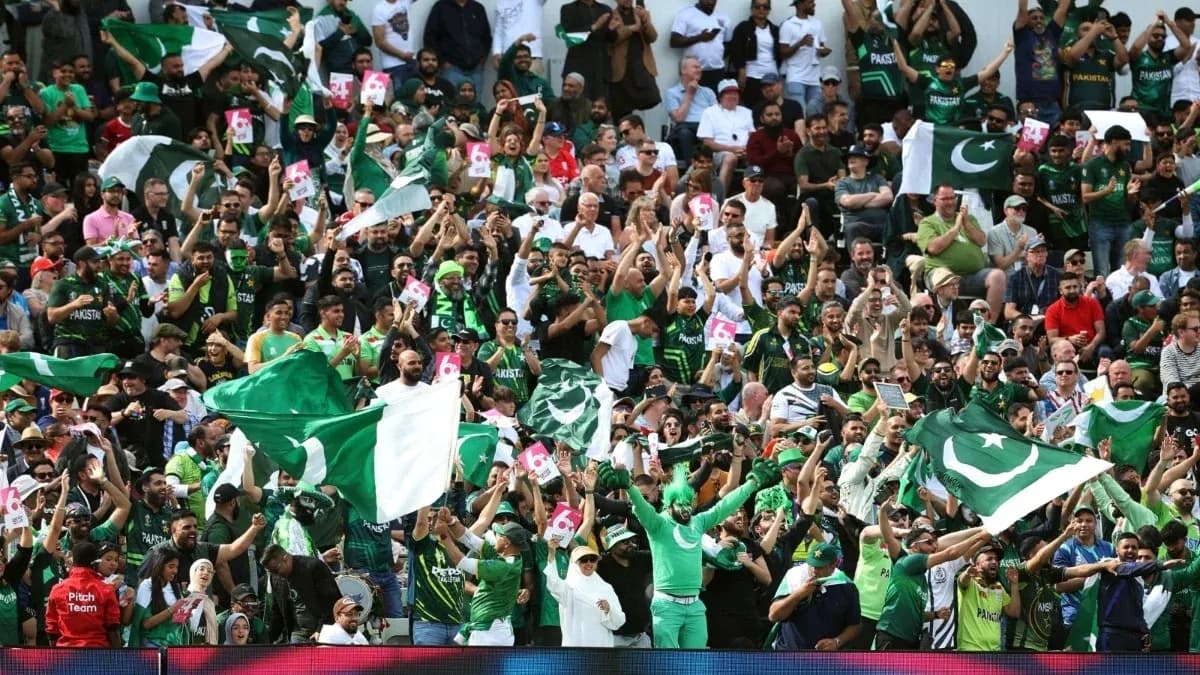 Crowd of Pakistani fans cheering with flags
