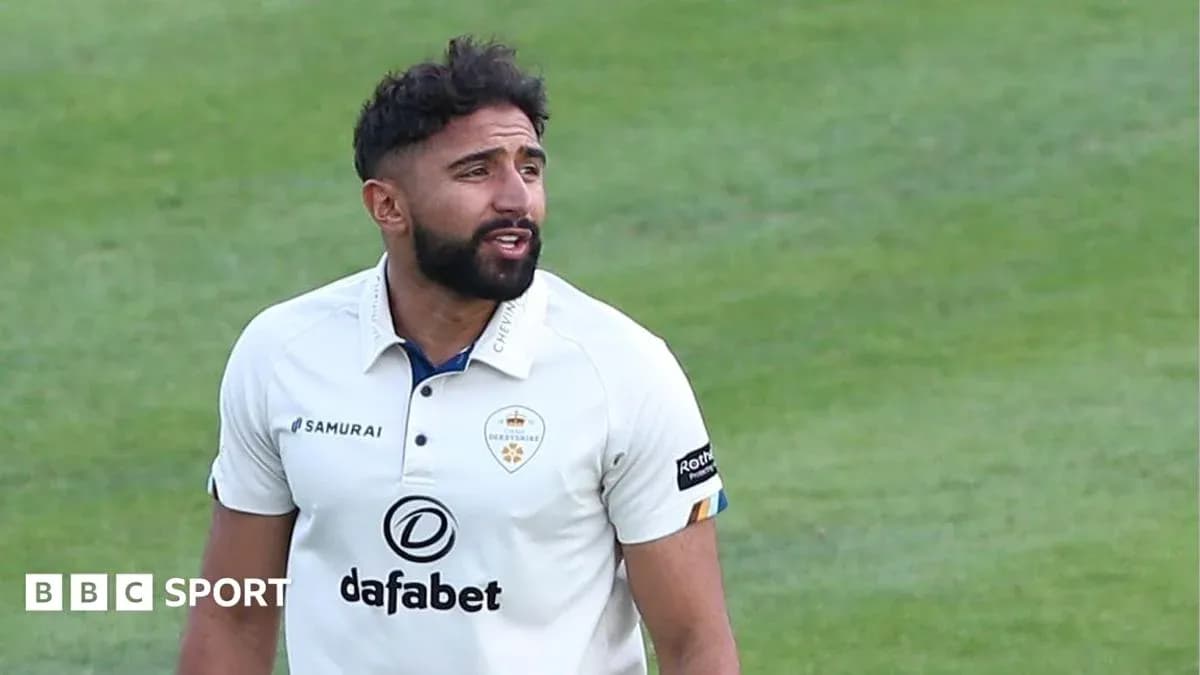 Cricketer wearing white kit on the field