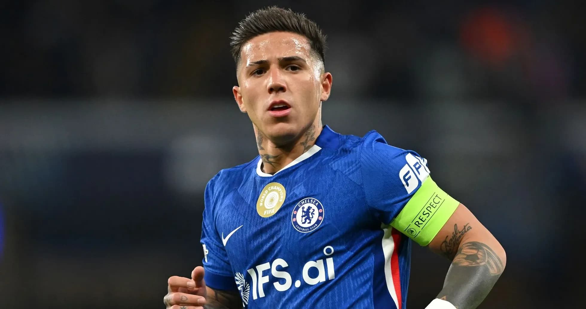 Player in blue Chelsea jersey with captain's armband