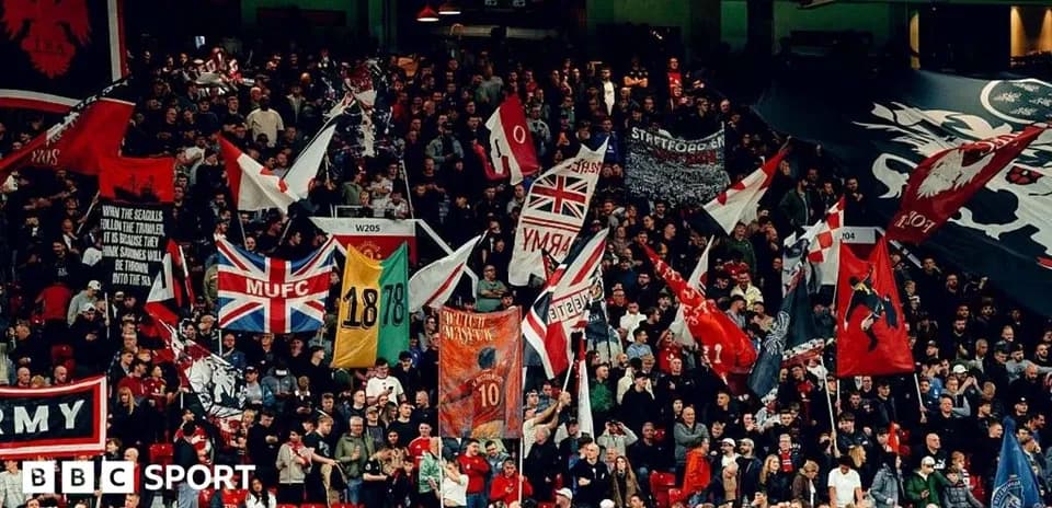 Crowd waving flags during a football match
