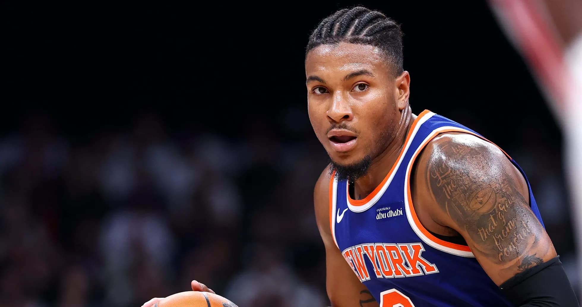 Player dribbling basketball in New York jersey