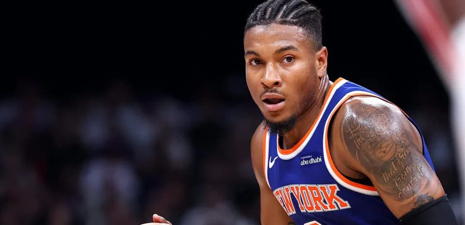 Player dribbling basketball in New York jersey