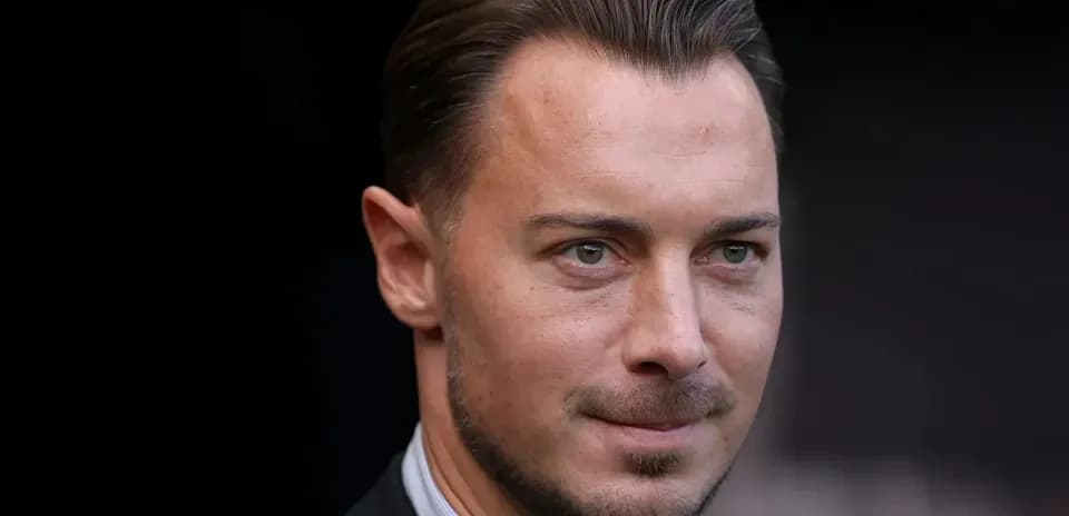 Close-up of a man in a suit outdoors