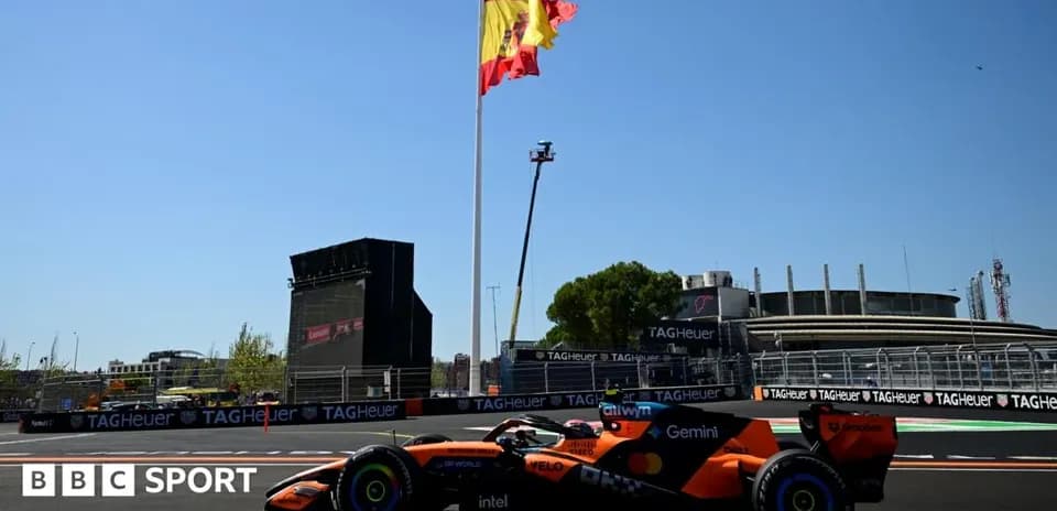 Formula 1 car racing near Spanish flag and grandstand