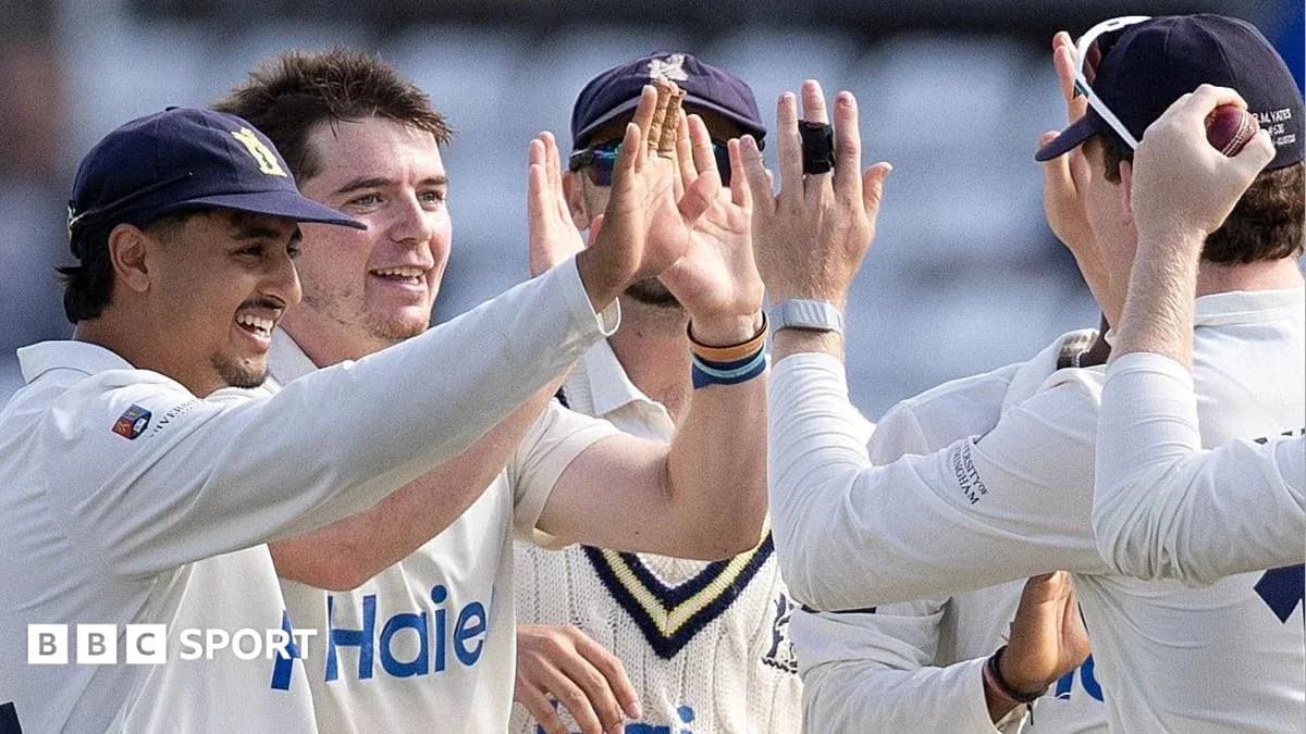 Cricket players celebrating a wicket together