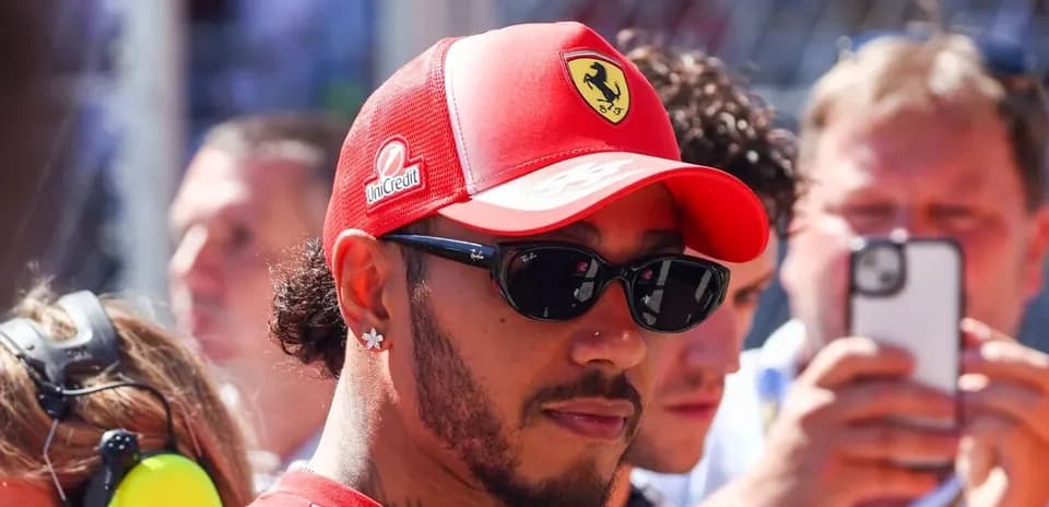 Driver in Ferrari cap and sunglasses at event
