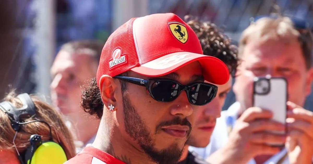 Driver in Ferrari cap and sunglasses at event