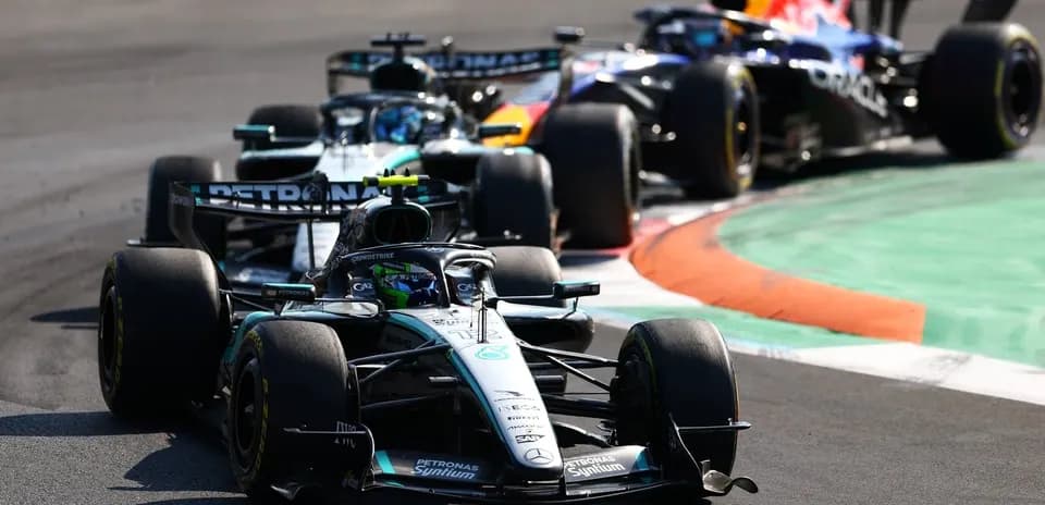 Formula 1 cars racing on a track corner