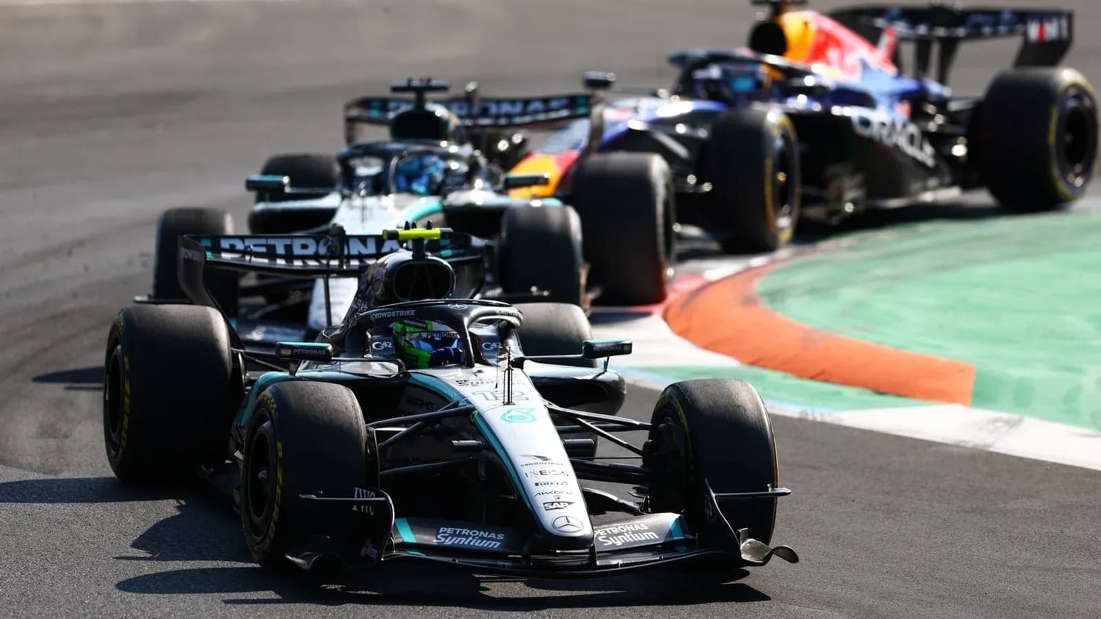 Formula 1 cars racing on a track corner
