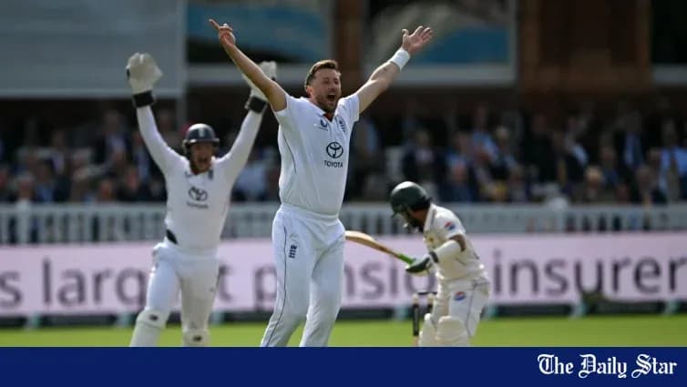 Bowler celebrating wicket with teammates on field