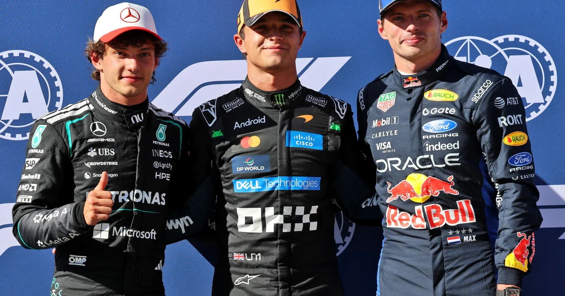 Three Formula 1 drivers posing together at event