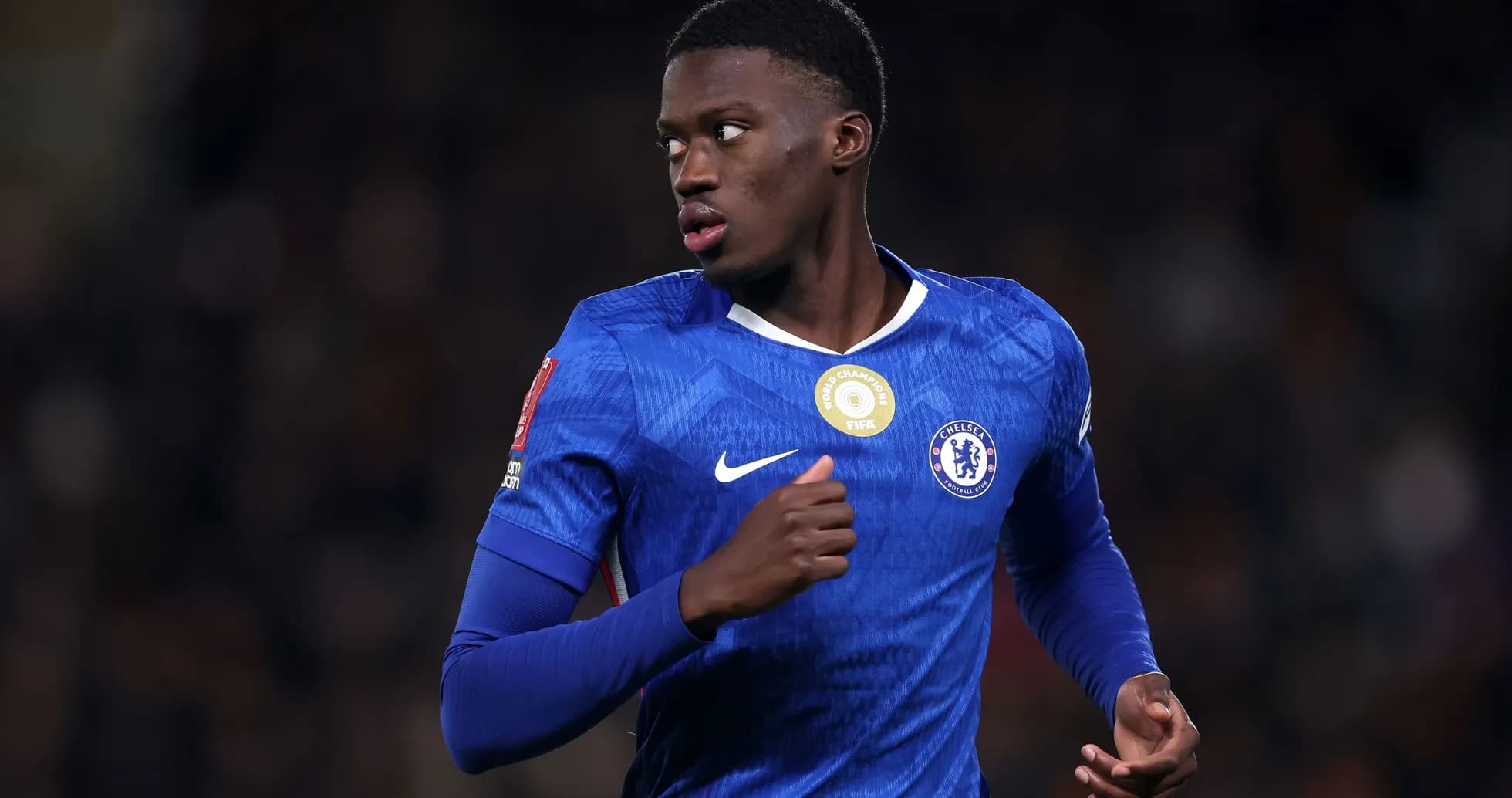 Chelsea player in blue jersey running on field