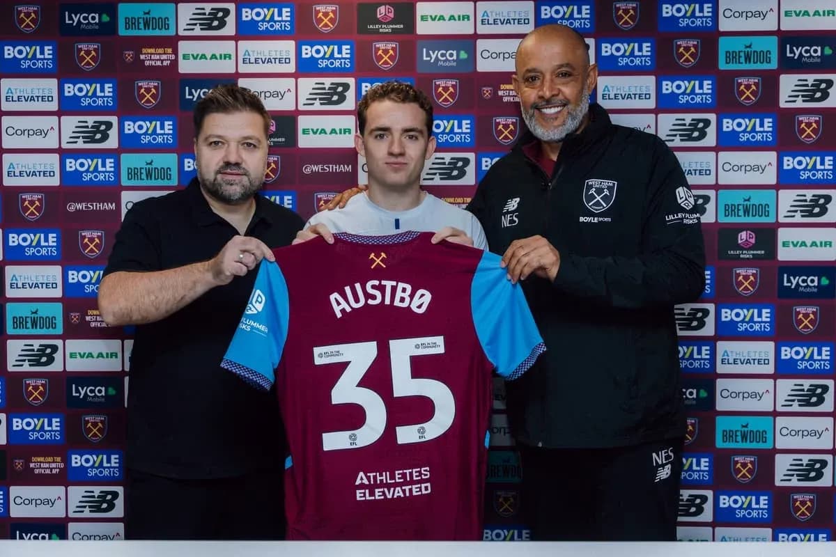 Player holding jersey with team officials at signing event