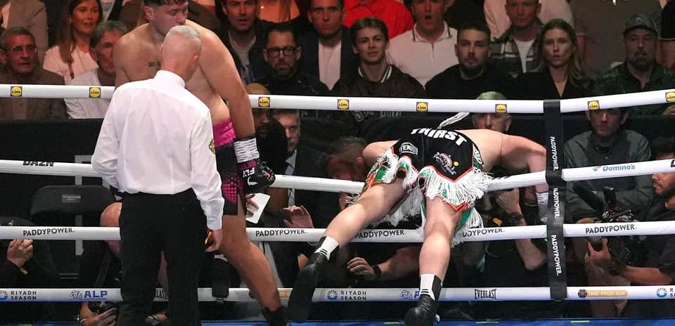 Boxer knocked down with referee checking on him