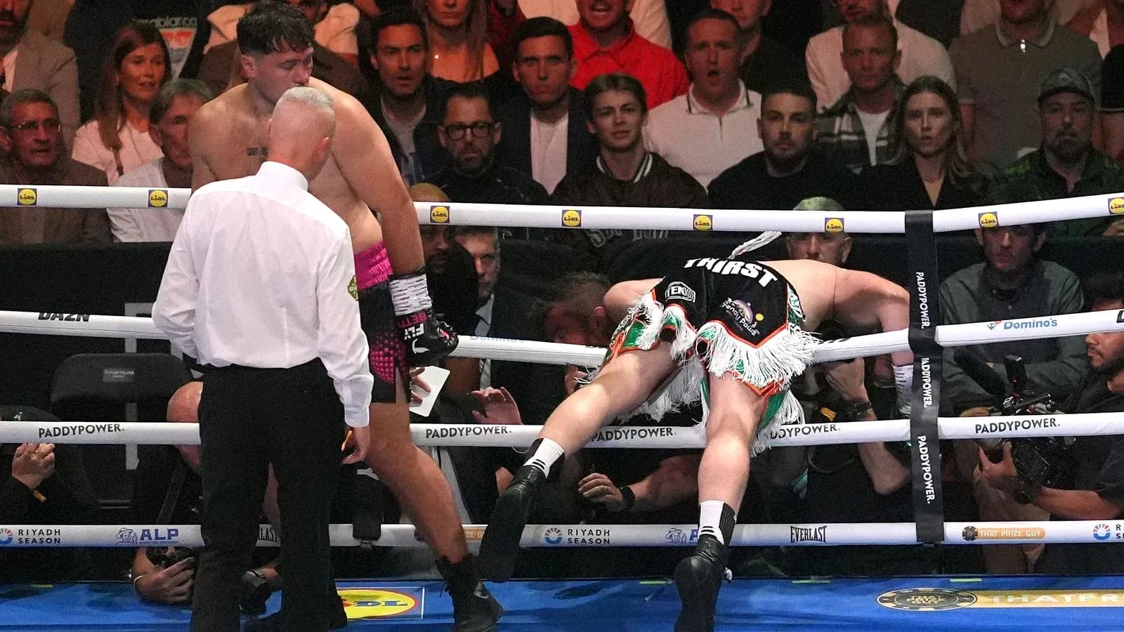 Boxer knocked down with referee checking on him