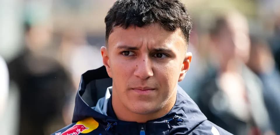 Driver wearing Red Bull jacket in paddock area