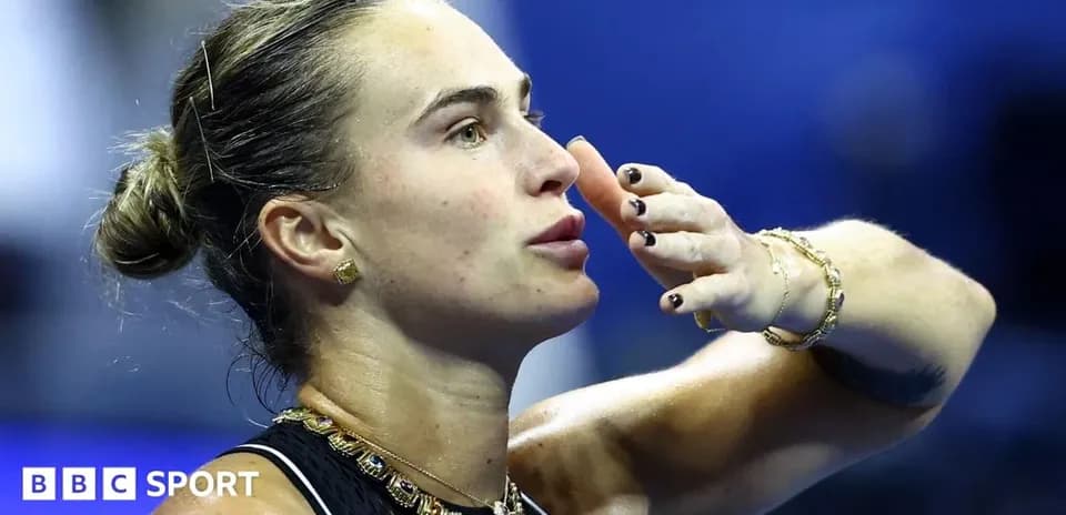 Tennis player blowing kiss after match point