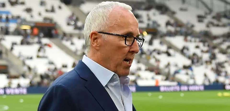 Manager walking near empty stadium before match