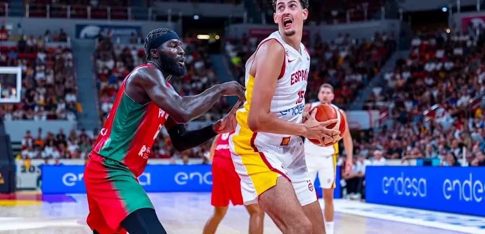 Spanish player holding basketball while being guarded