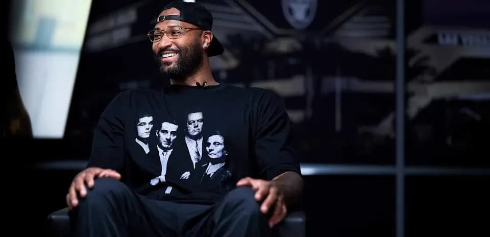 Player seated in interview setting wearing graphic t-shirt