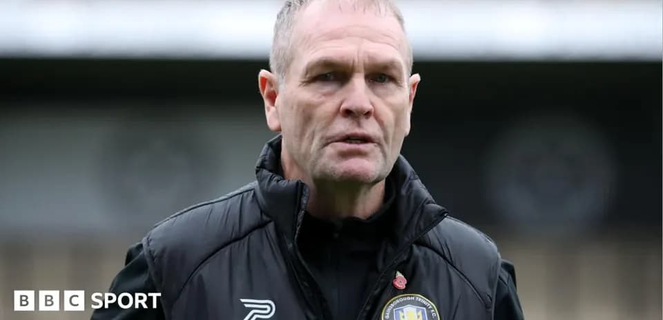 Football manager speaking on the pitch sidelines
