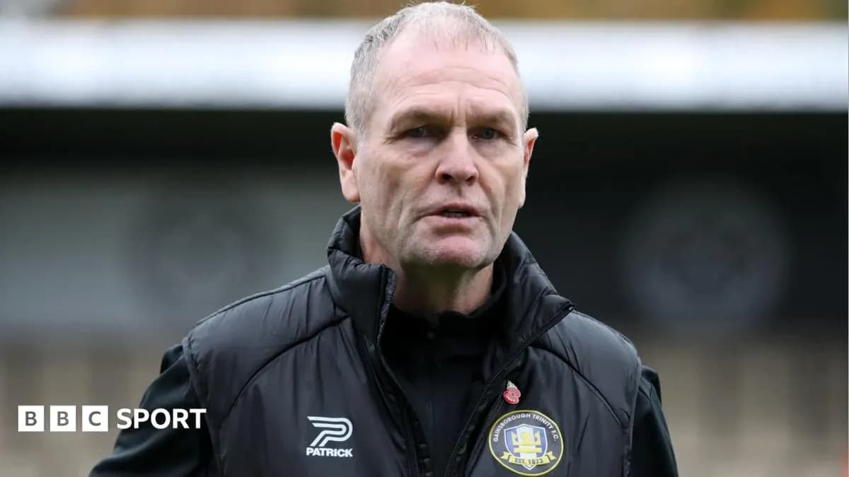 Football manager speaking on the pitch sidelines