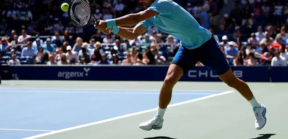 Player returning a shot during tennis match