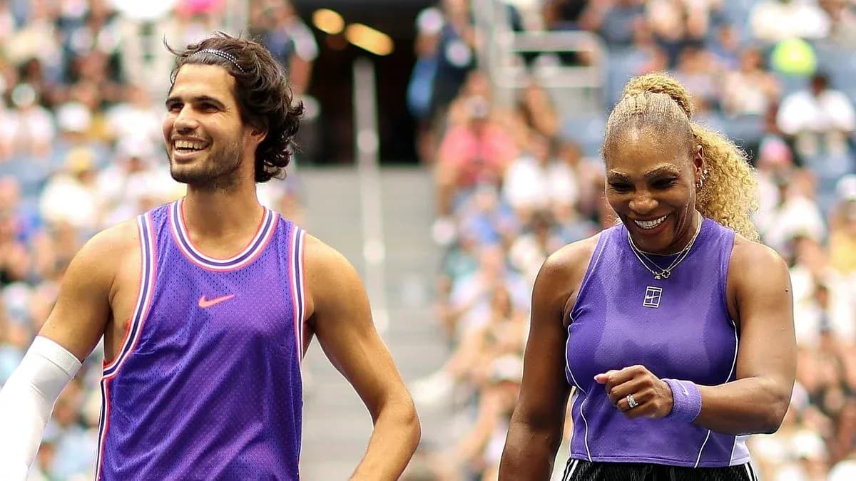Two tennis players smiling on court during match