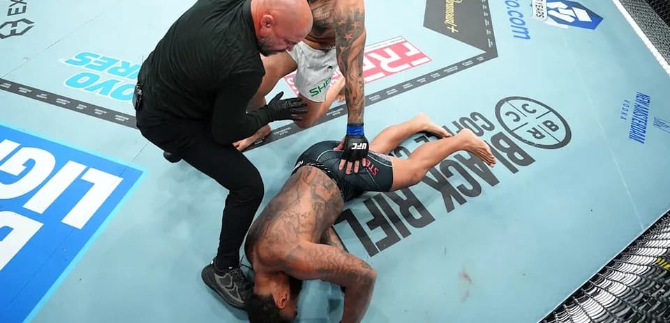 Fighter on the ground with referee checking on him