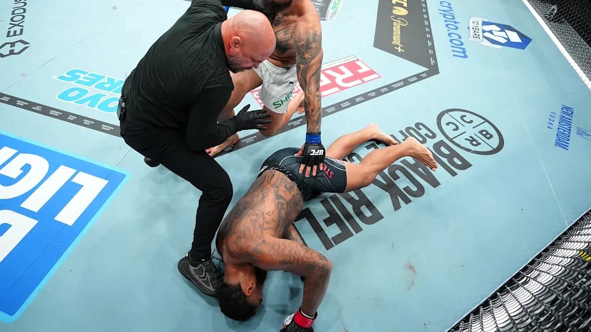Fighter on the ground with referee checking on him