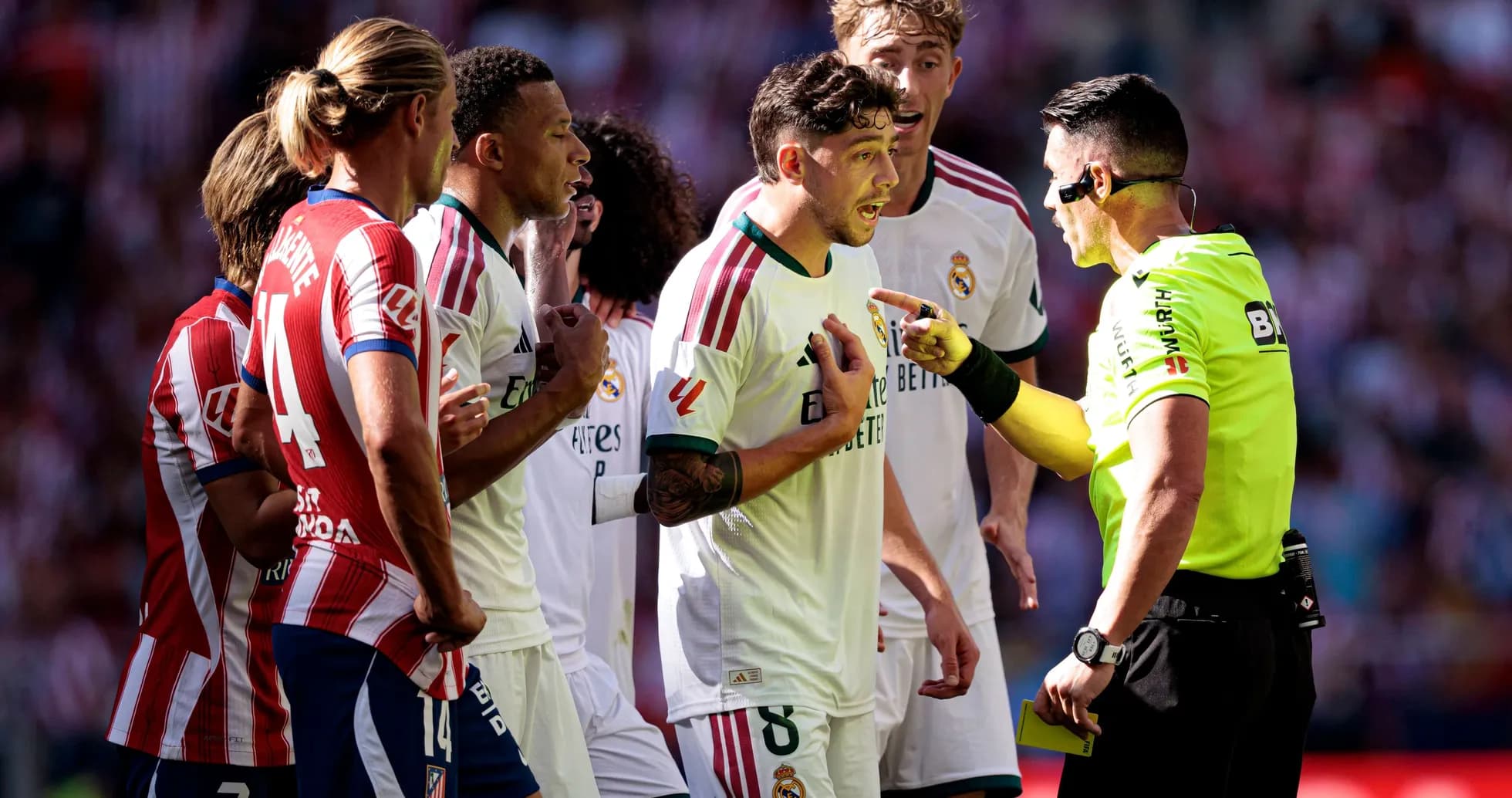 Players arguing with referee during football match