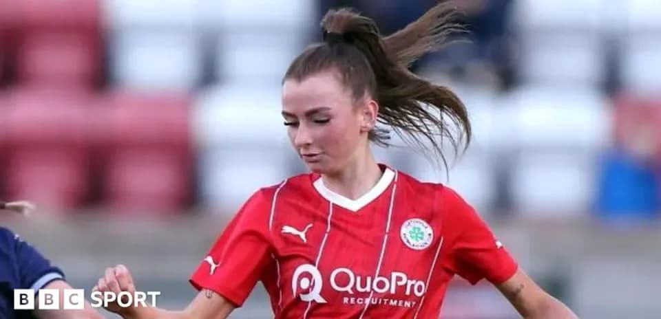 Player in red jersey dribbling the ball