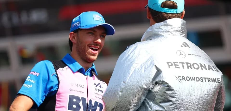 Two drivers chatting in team uniforms at event