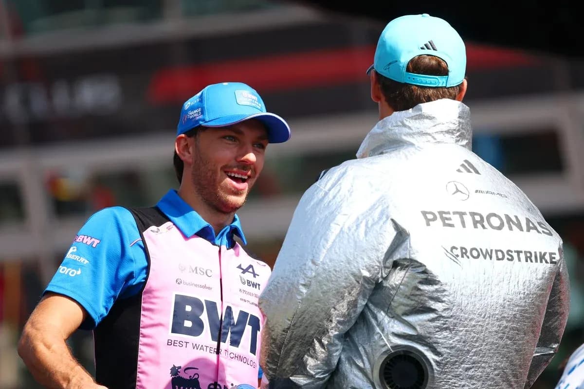 Two drivers chatting in team uniforms at event