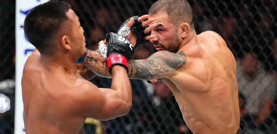 Two fighters exchanging punches in octagon