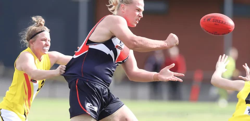 Player attempting to pass the football under pressure