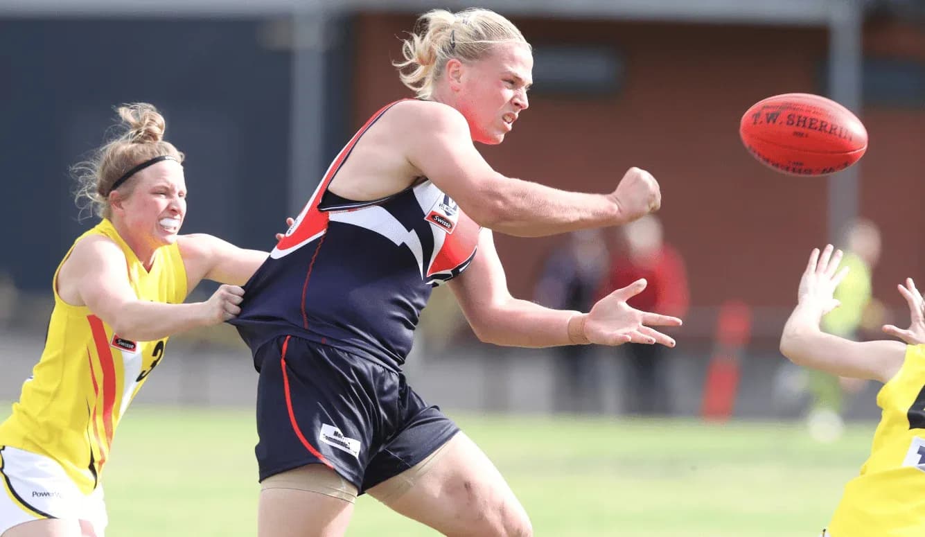 Player attempting to pass the football under pressure