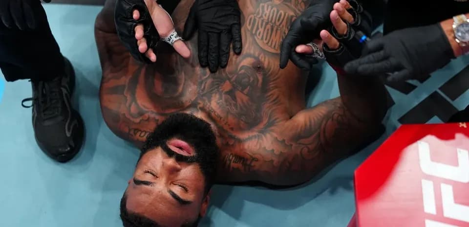 Fighter receiving medical attention in the octagon