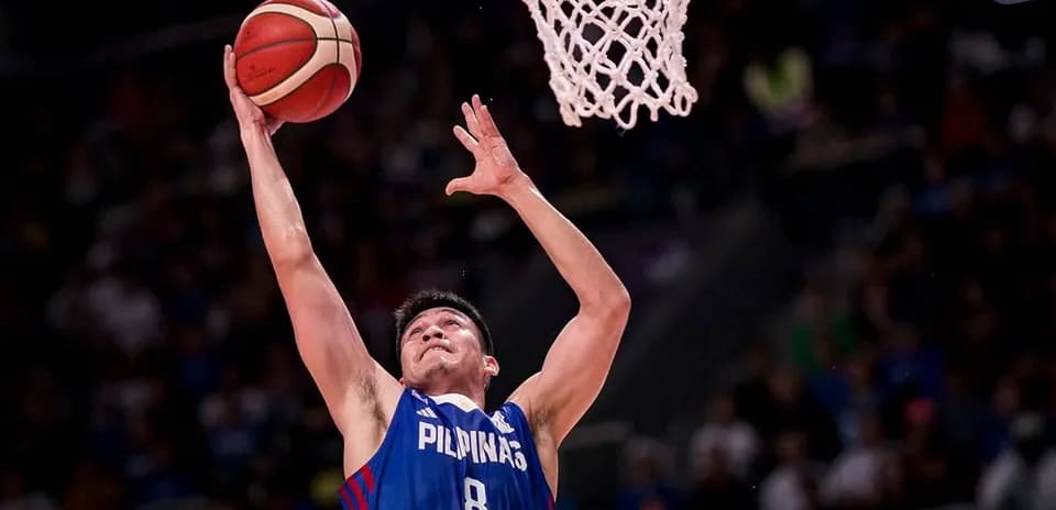 Player jumping to score during basketball game