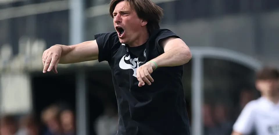 Coach passionately directing players on the sidelines