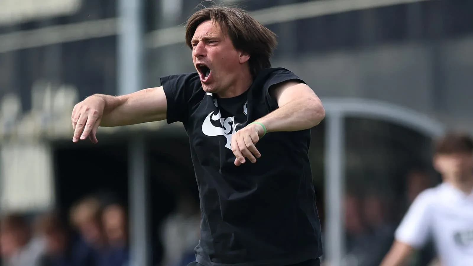 Coach passionately directing players on the sidelines