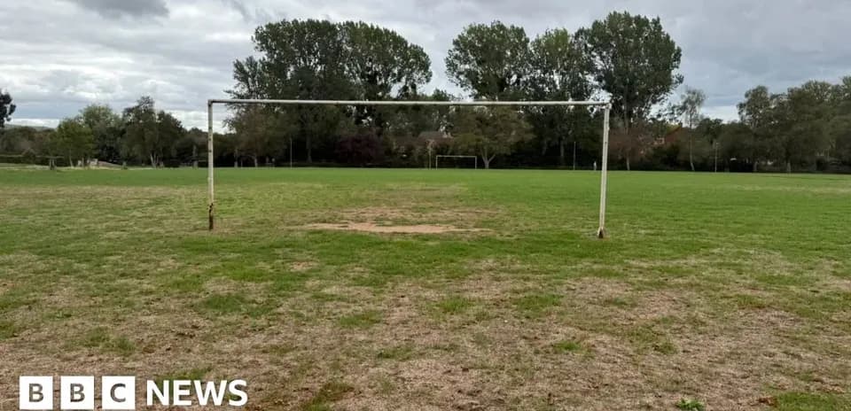 Empty football goalpost on grassy field