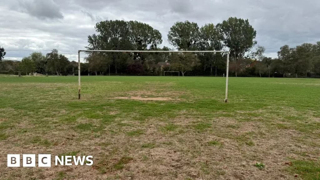 Empty football goalpost on grassy field