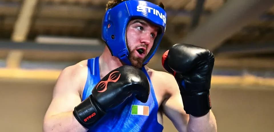 Boxer wearing headgear and gloves in training session