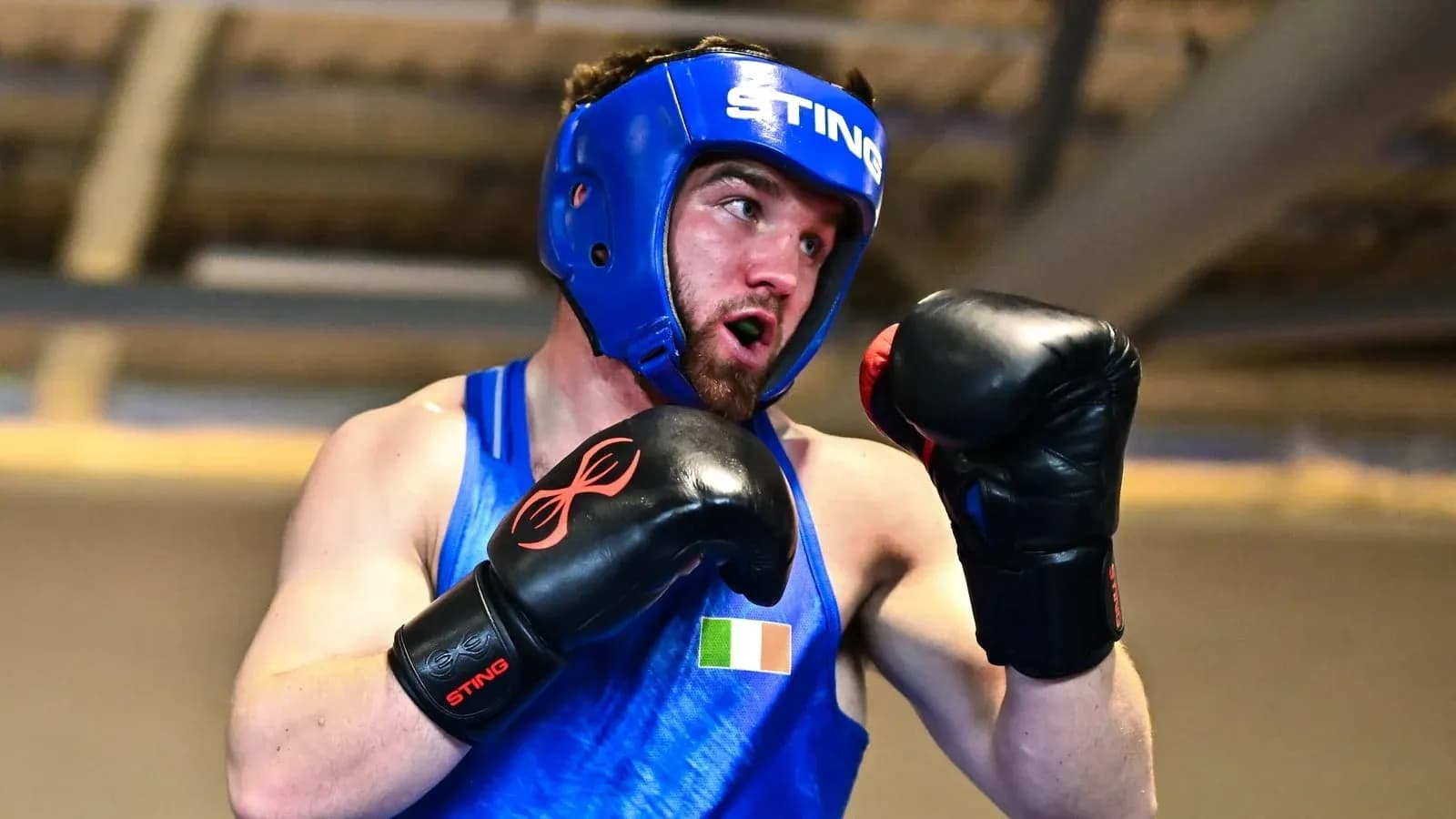 Boxer wearing headgear and gloves in training session